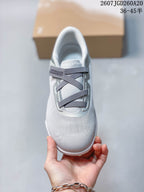 Top view of the sneaker showing the rounded toe, gray crossed straps, padded tongue, and On logo.