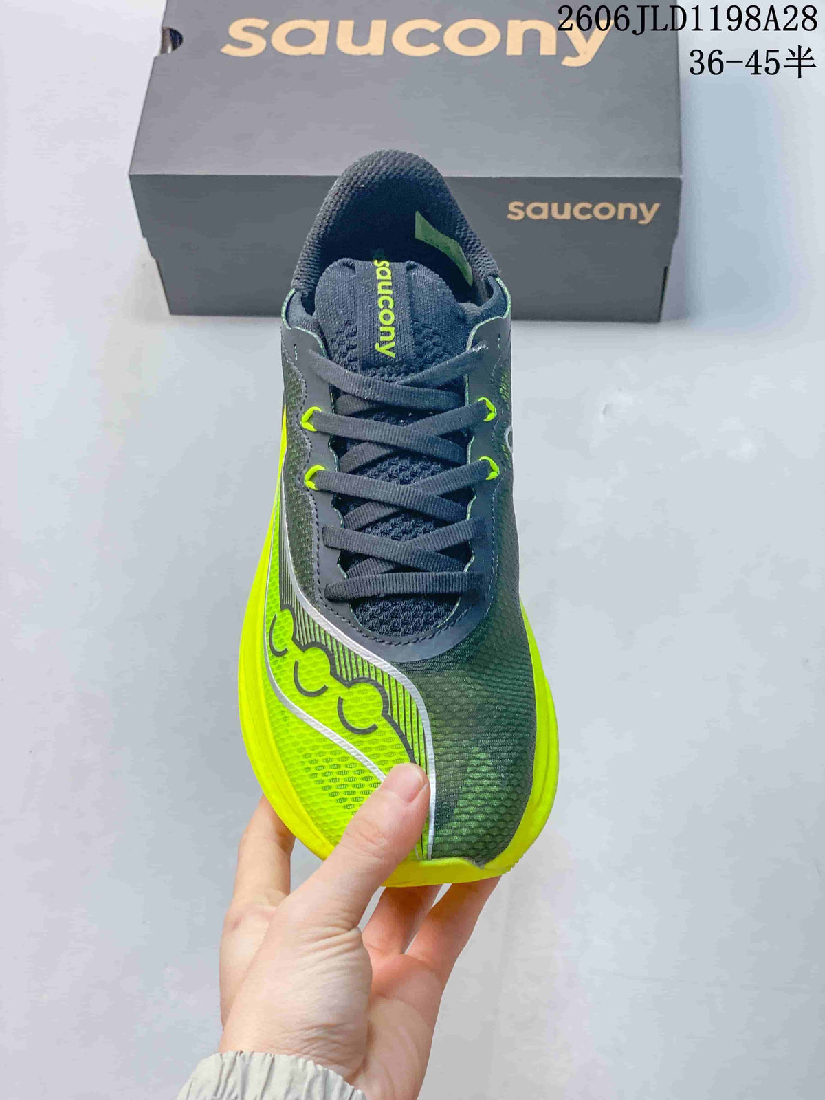 Front view showing the laces, gray upper, and yellow side accents