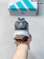 Rear view of the adidas shoe showing the padded collar, heel branding and white midsole.