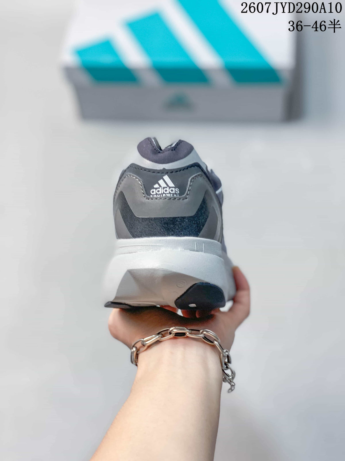 Rear view of the adidas shoe showing the padded collar, heel branding and white midsole.
