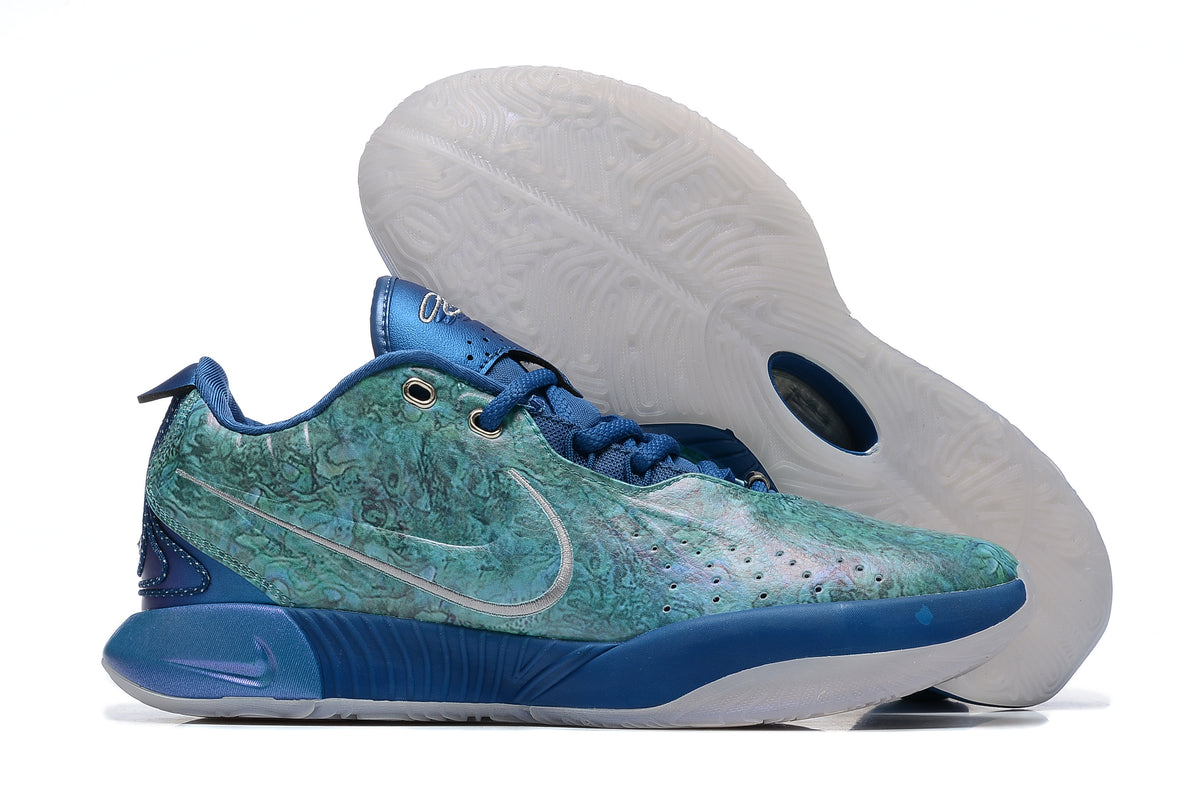 Blue and teal patterned Nike basketball shoes with a translucent-looking outsole.