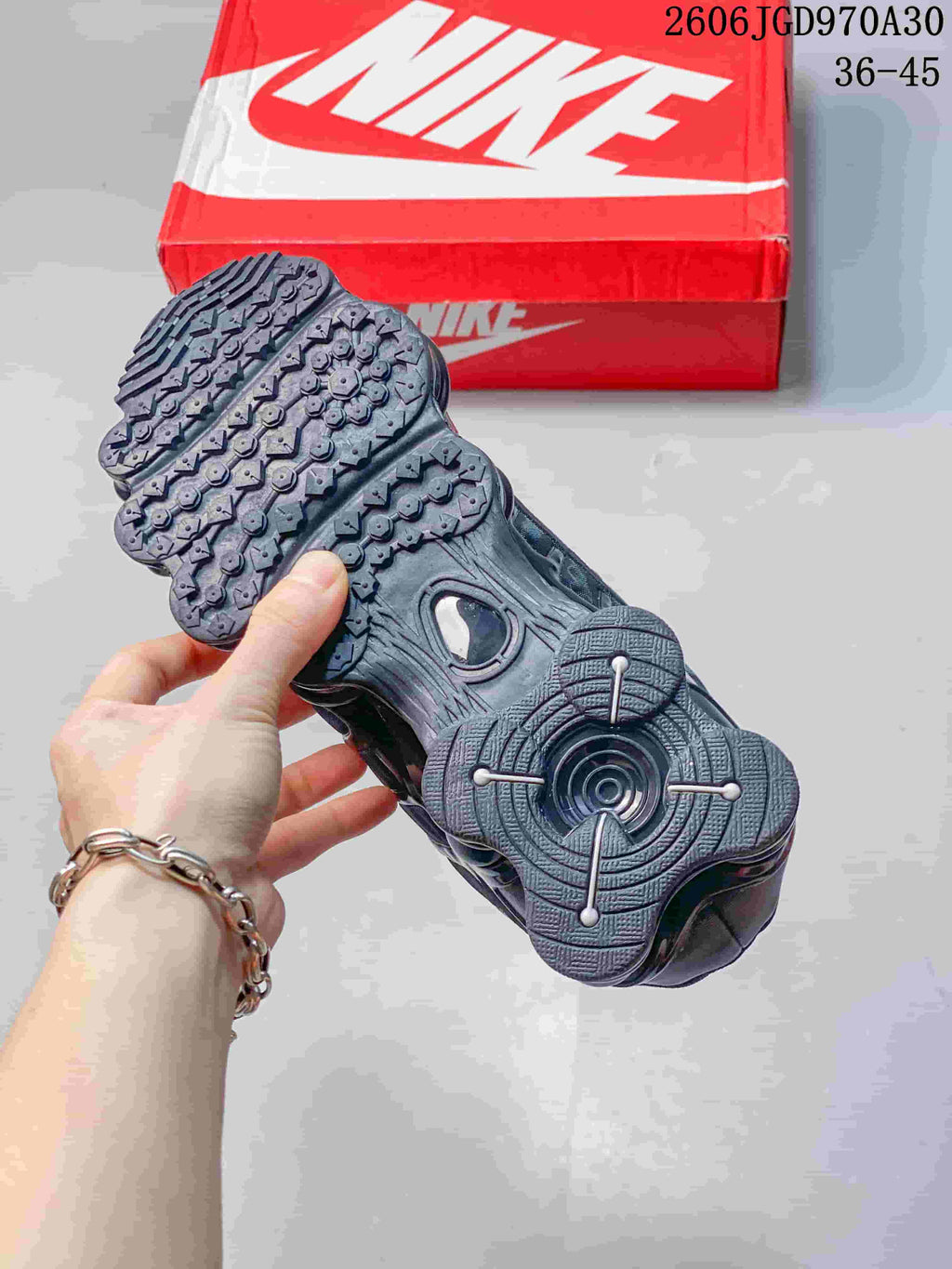 Close-up of the sneaker outsole showing its tread pattern and segmented heel cushioning