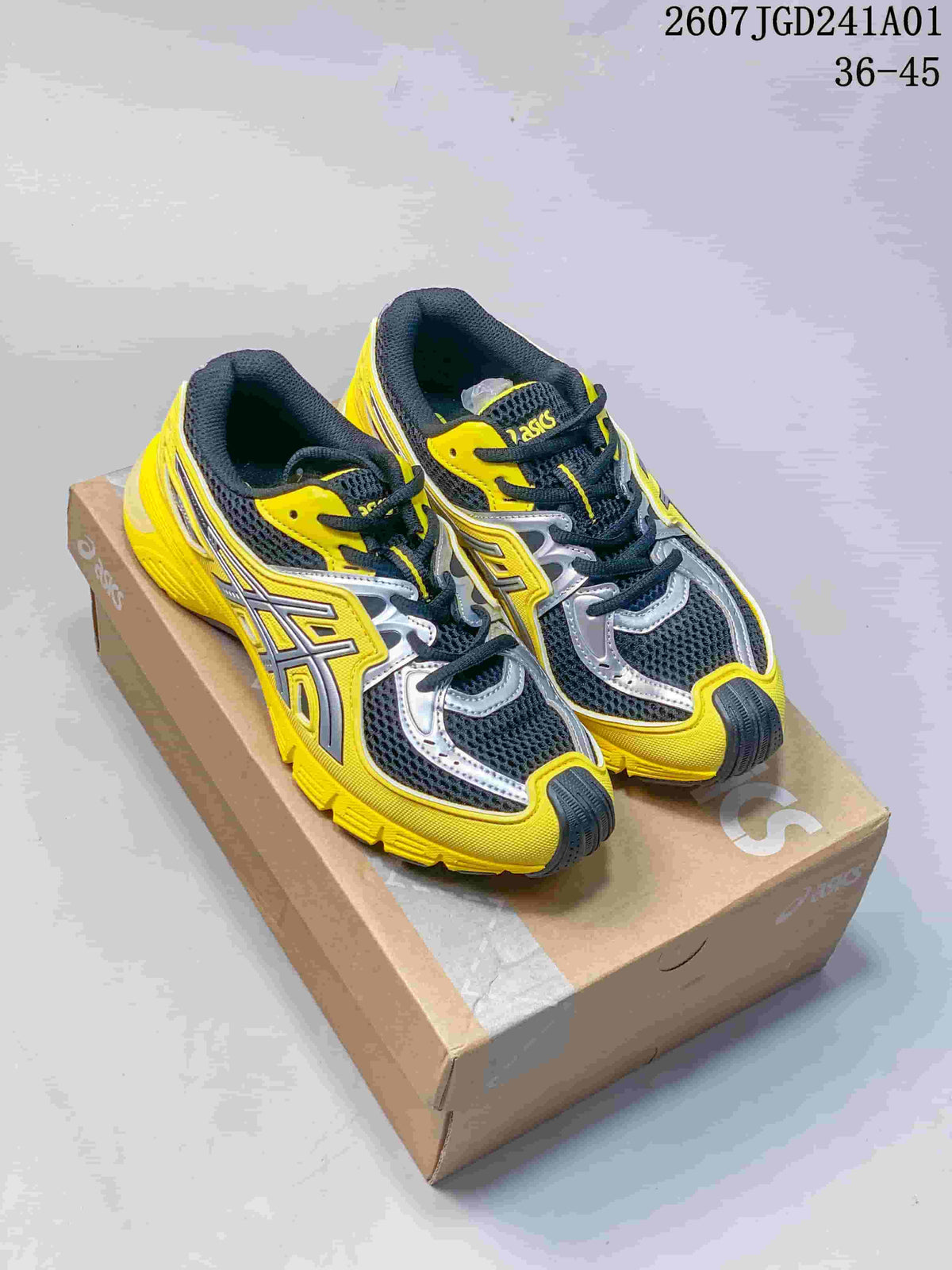 Pair of yellow, charcoal, and silver ASICS GEL-SD Lyte sneakers on a shoebox.