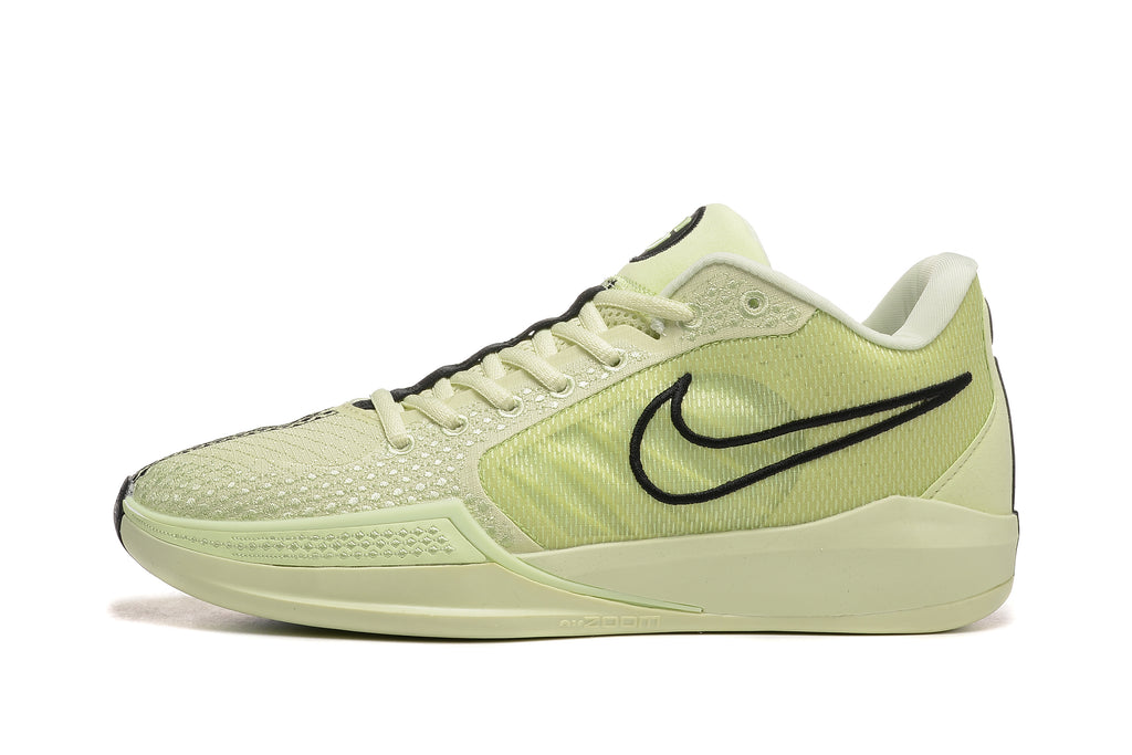Side profile of a pale yellow-green Nike Sabrina 10 shoe with a black Swoosh