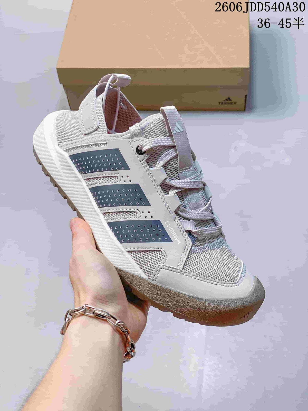 Light gray Adidas Terrex Daroga 25 sneaker with dark side panels and a ridged outsole.