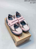 Pair of pink, gray, and dark navy New Balance Mary Jane sneakers displayed on a New Balance shoe box; image text shows sizes 36–42.