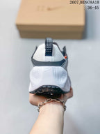 Rear view of a sneaker showing the white heel, pull tab, padded collar, and black outsole.