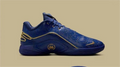 Side view of a blue Nike LeBron 22 basketball shoe with patterned panels and gold-tone accents