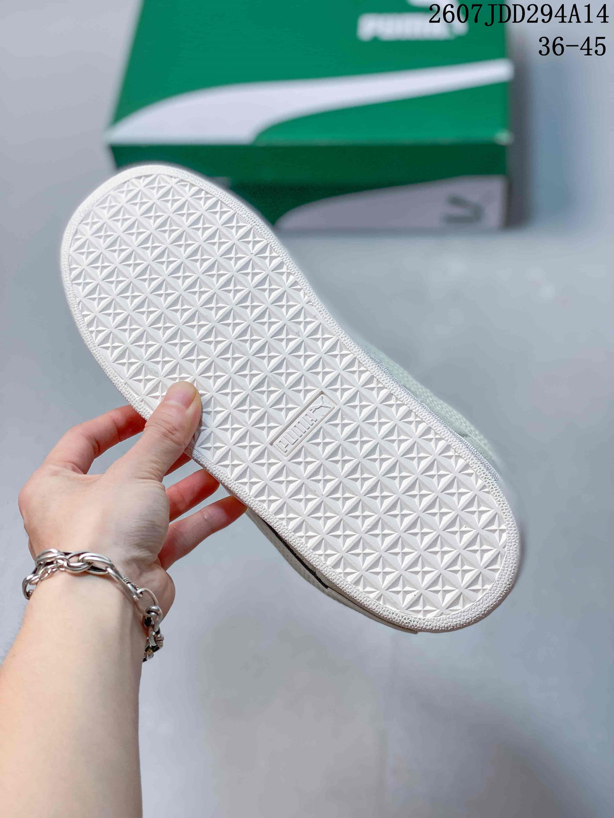 Close-up of the white outsole showing its repeating geometric tread pattern and embossed branding.