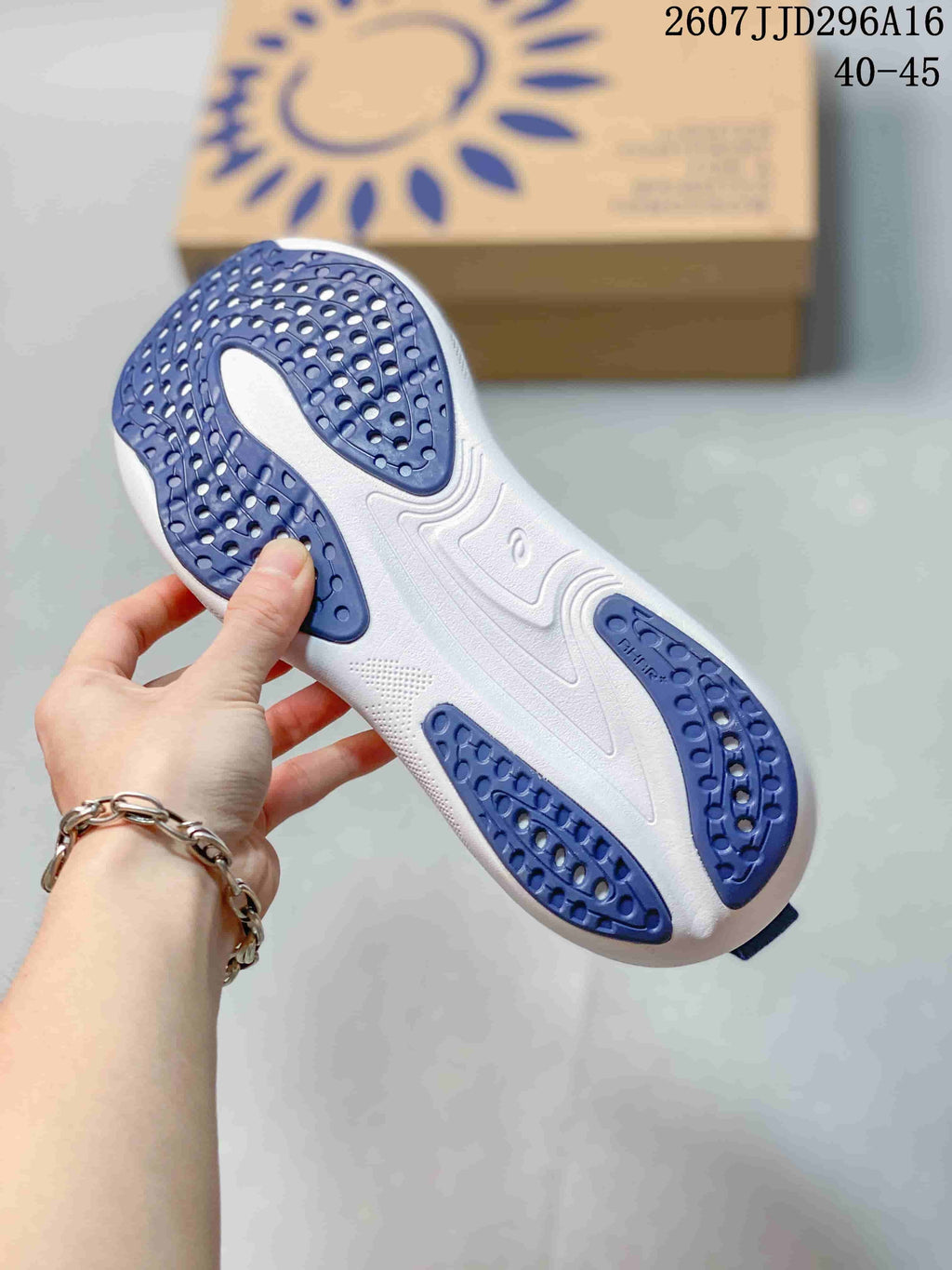 Underside view showing the white outsole with blue traction sections on an ASICS running sneaker.