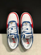 Top view showing white perforated toe boxes, blue eyestays, white laces, and branded insoles.