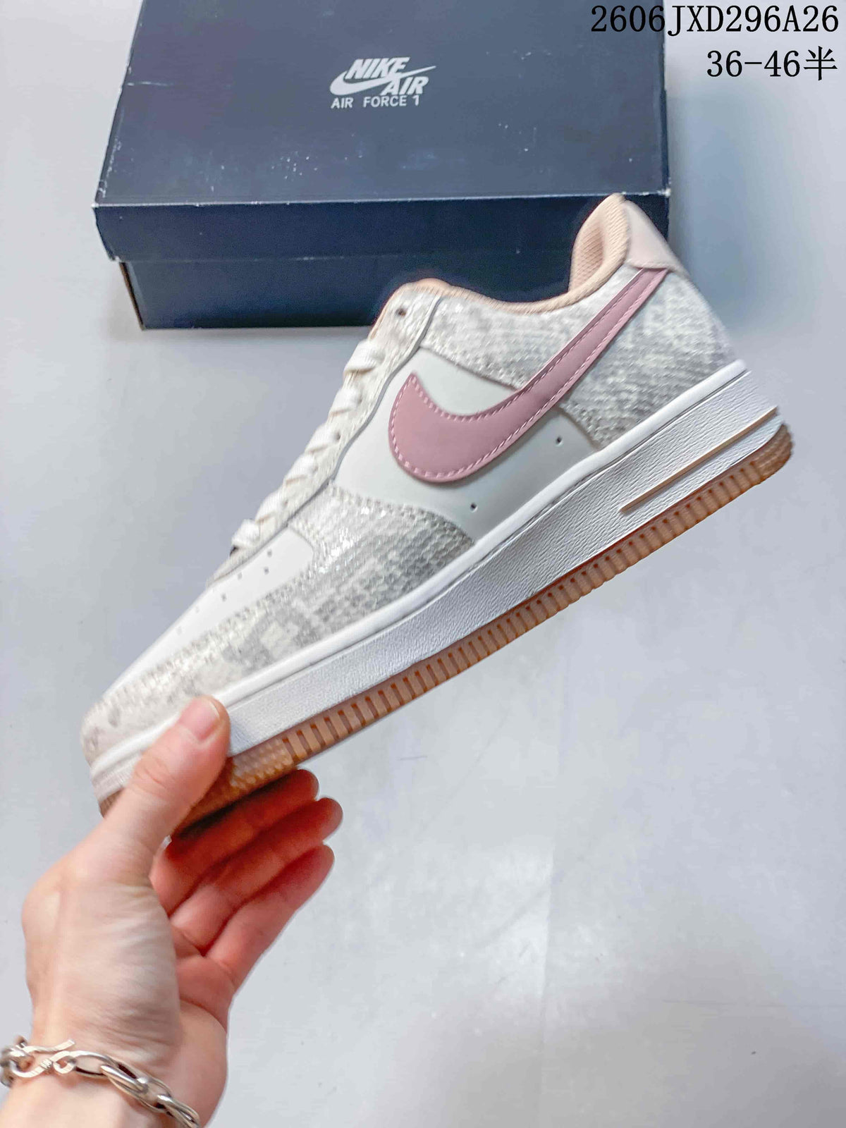 Side view of low-top sneaker with pink Swoosh and gum-colored outsole