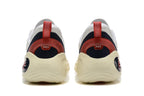 Rear view of white basketball shoes with dark heel panels and red pull tabs