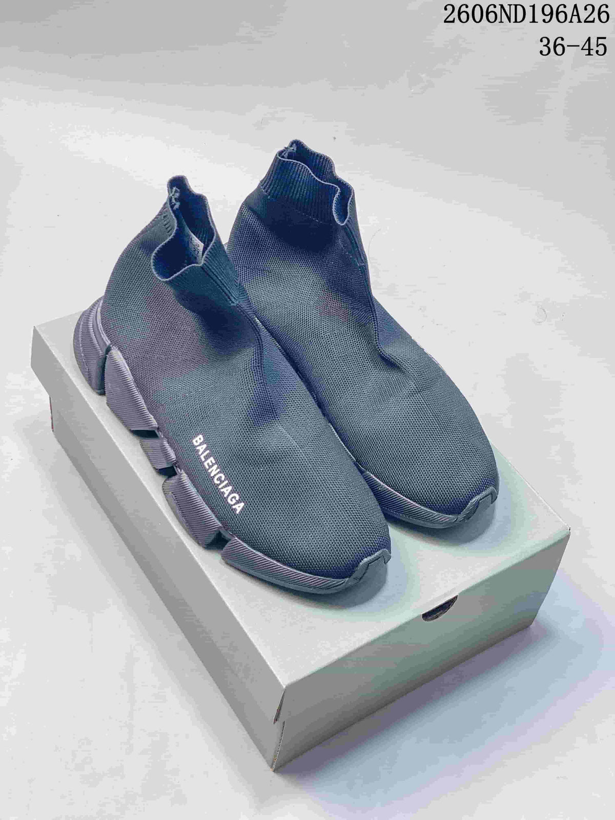 Pair of dark gray Balenciaga sock sneakers displayed on a shoebox, showing the knit uppers and segmented outsole.