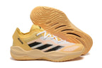 Yellow Adidas Adizero shoe beside its patterned outsole