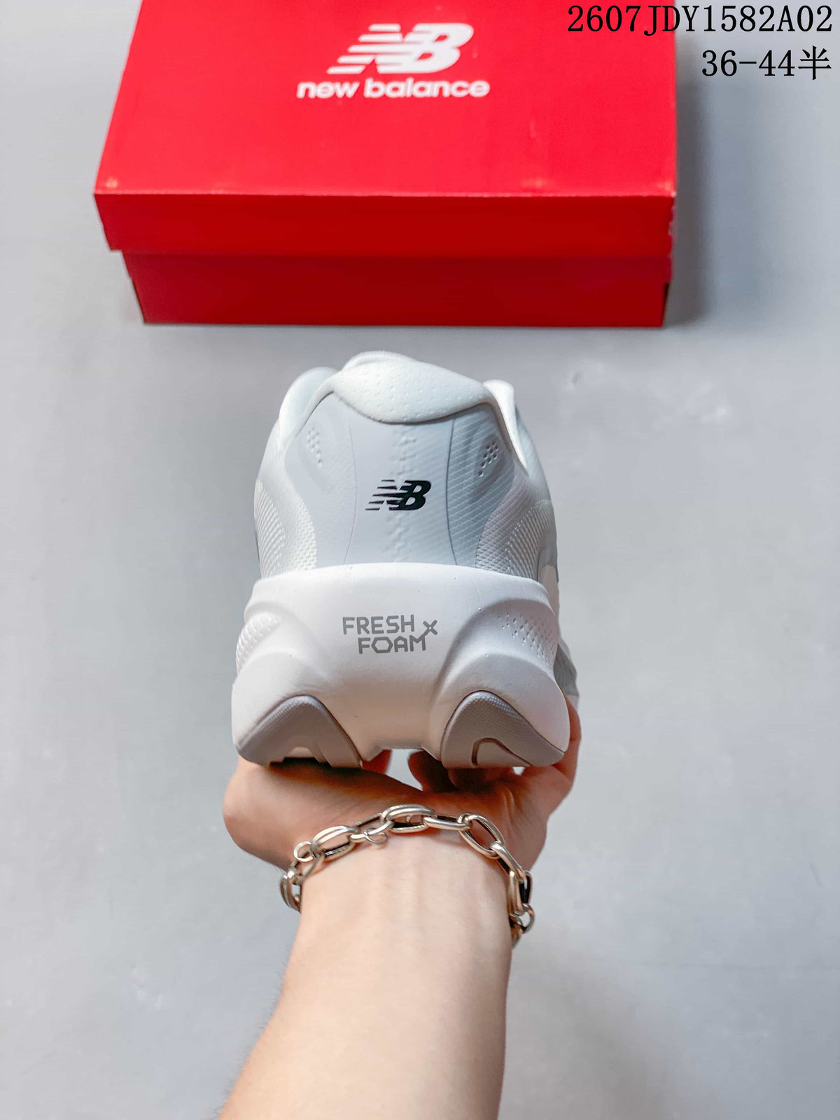 Rear view of a white New Balance shoe showing Fresh Foam X lettering on the midsole.