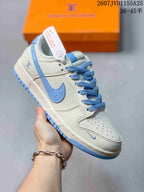 Angled side view showing the white and light blue upper, blue laces, and layered sole.