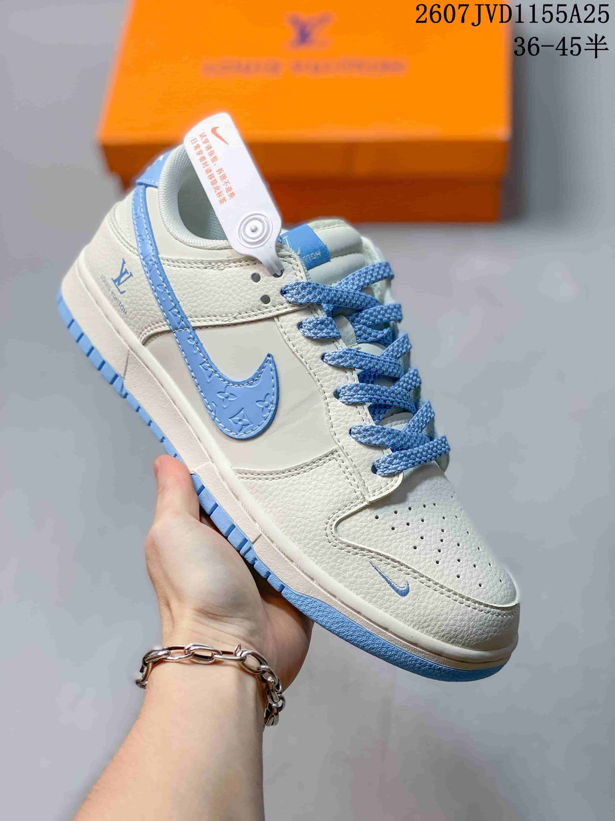 Angled side view showing the white and light blue upper, blue laces, and layered sole.