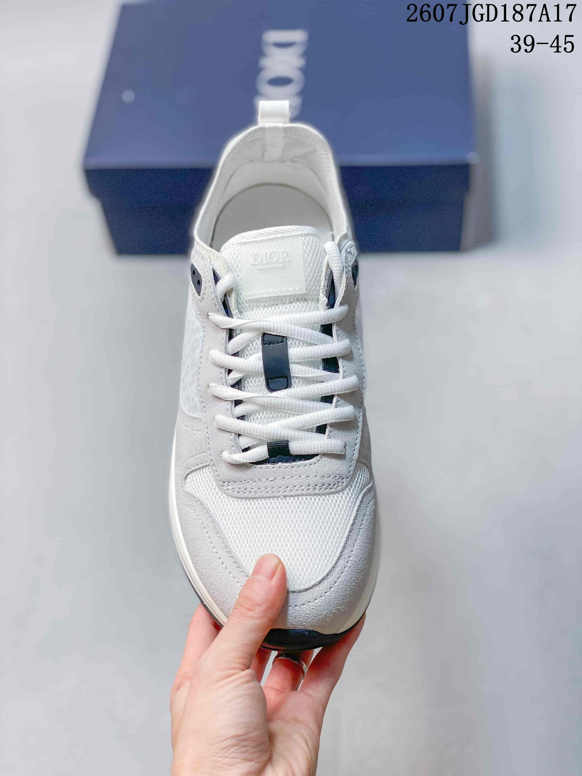 Front view showing the white laces, contrasting dark lace details, tongue branding, and textured toe panel.