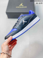 Side profile of the black and blue low-top sneaker showing the Jordan logo, white midsole, and blue outsole.