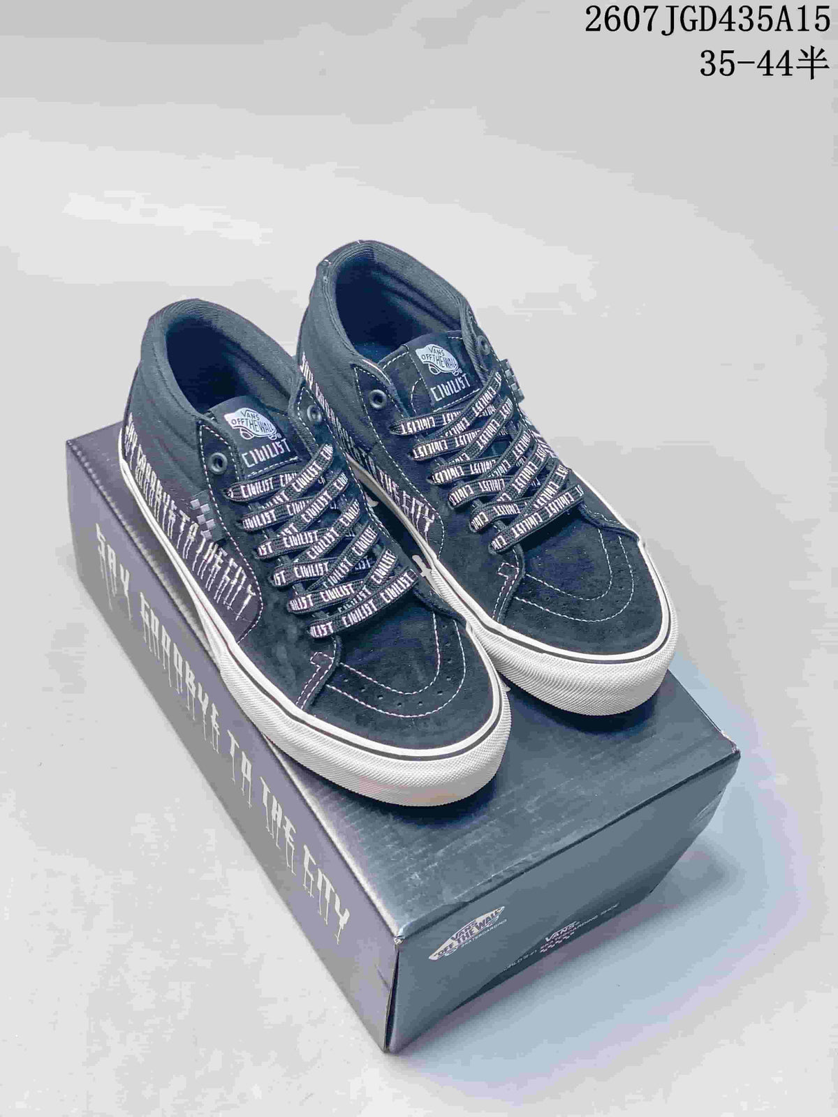 Pair of black Vans sneakers with patterned laces displayed on a branded shoe box.