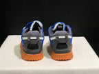 Rear view showing the padded collars, heel pull tabs, layered heel panels, and textured gum-colored soles.