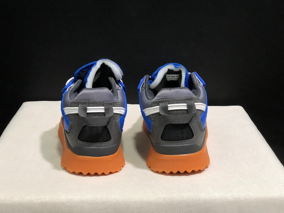 Rear view showing the padded collars, heel pull tabs, layered heel panels, and textured gum-colored soles.
