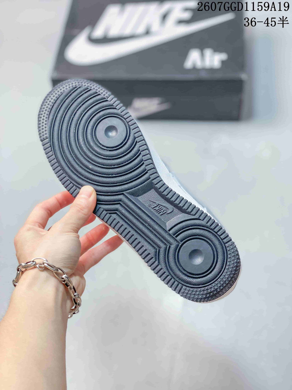 Bottom view of the sneaker showing the dark circular-tread outsole.