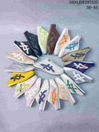 Group display of Onitsuka Tiger Mexico 66 Sabot slip-on sneakers in assorted colors and stripe combinations.