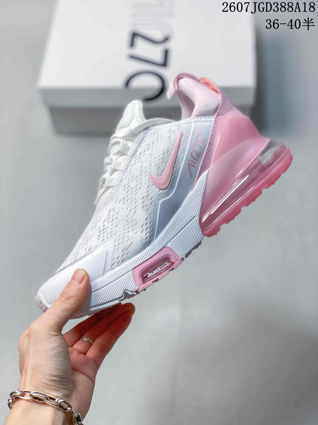 Side view of the white and pink sneaker showing the Swoosh, Air Max 270 branding, perforated-looking upper, and heel unit.