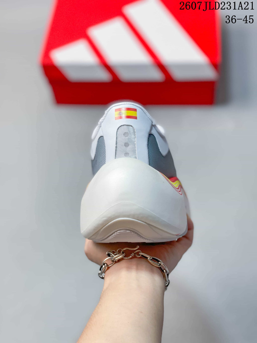 Rear view of the white sneaker showing the padded heel and layered sole construction.