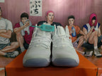 Front view of white lace-up Nike high-top basketball shoes