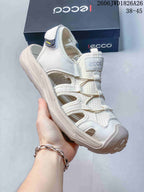 Close-up of an off-white open-toe sandal with adjustable lacing and a protective toe bumper.