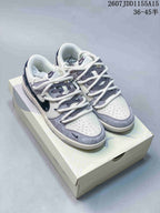 Pair of white and gray low-top sneakers with navy Swooshes, patterned laces and gray toe overlays.