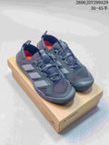 Pair of dark gray Adidas Terrex sneakers displayed on a Terrex shoe box, with the size range 36–45 shown in the upper right.
