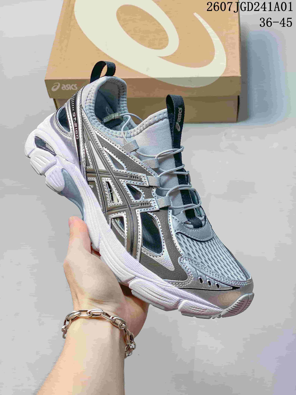 Angled view of a silver-toned ASICS GT-2160 Breeze sneaker with open mesh panels and a sculpted outsole.