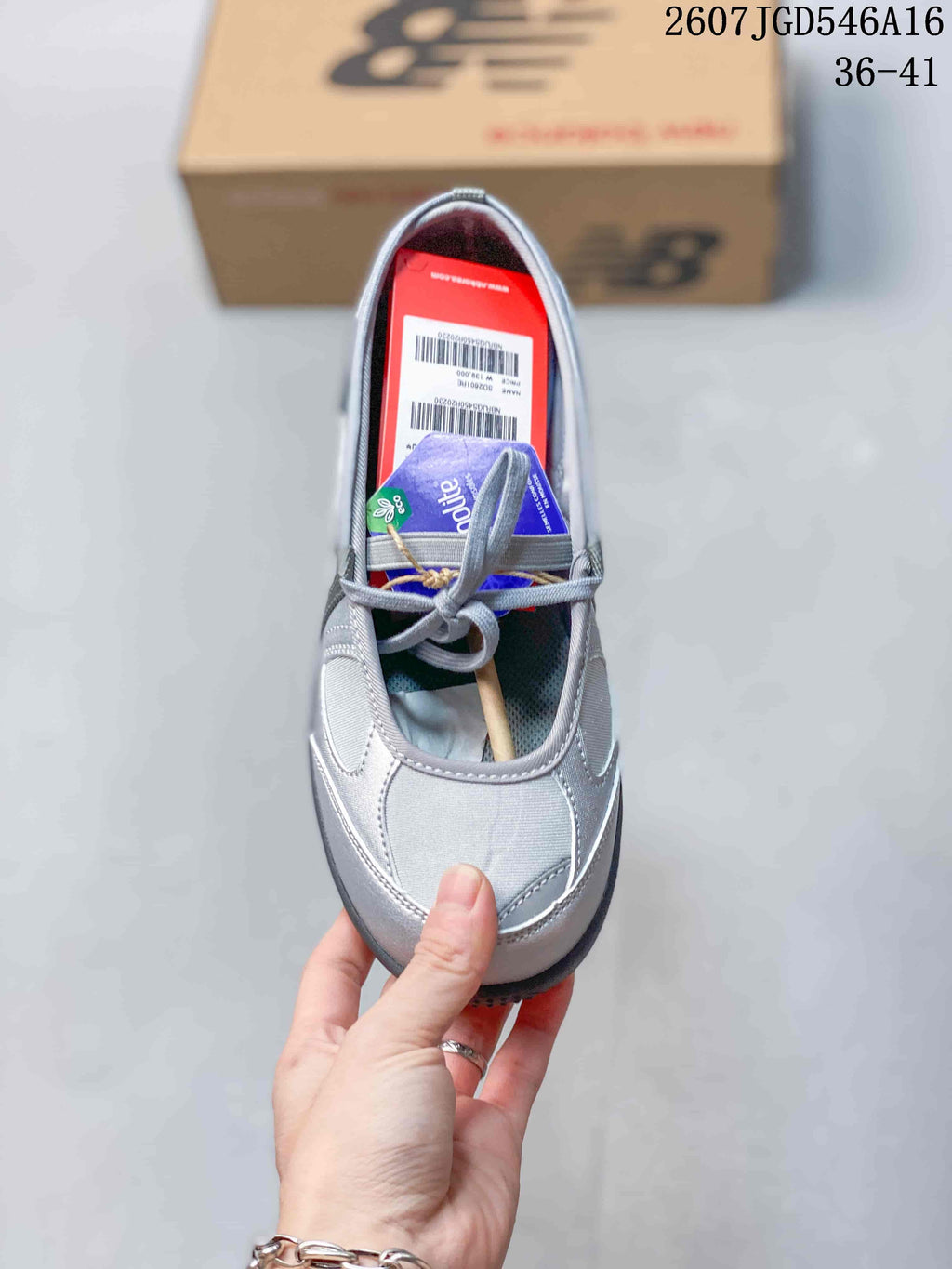 Top view of the silver-gray shoe showing the rounded toe, cross straps, inner label area, and dark footbed.