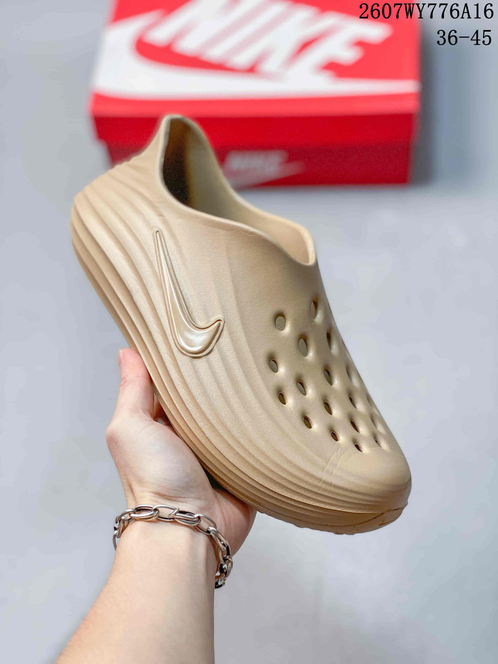 Angled view of the tan clog showing the perforated upper, sculpted side profile, and raised Nike Swoosh detail.