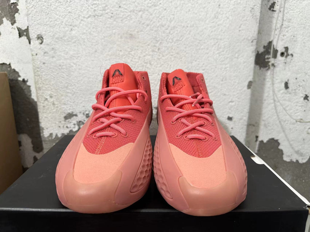Front view of pink Adidas mid-top sneakers with lace-up closure.