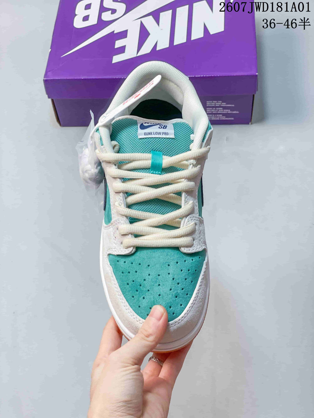 Top view of a Nike SB Dunk Low Pro sneaker showing its teal perforated toe and white laces.
