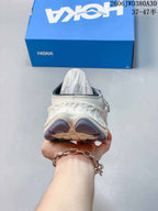 Rear view of a gray and cream HOKA Ora Primo EXT mule shoe