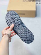 Close view of the patterned tread outsole on a black sneaker, with the marked size range 39–45 visible in the image.