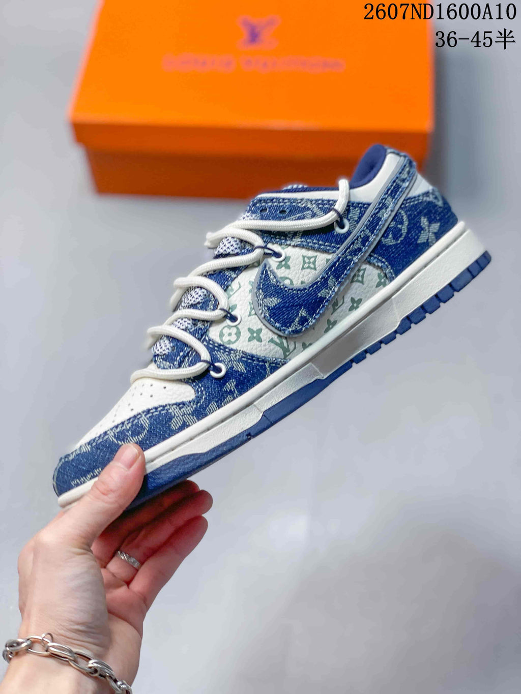 Side profile showing the blue and white upper, patterned panels, layered overlays, and white midsole.