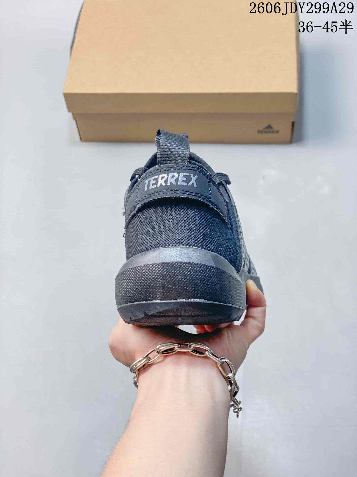 Rear view of a dark gray Terrex sneaker showing the heel pull tab, padded heel area, and rubber heel section.