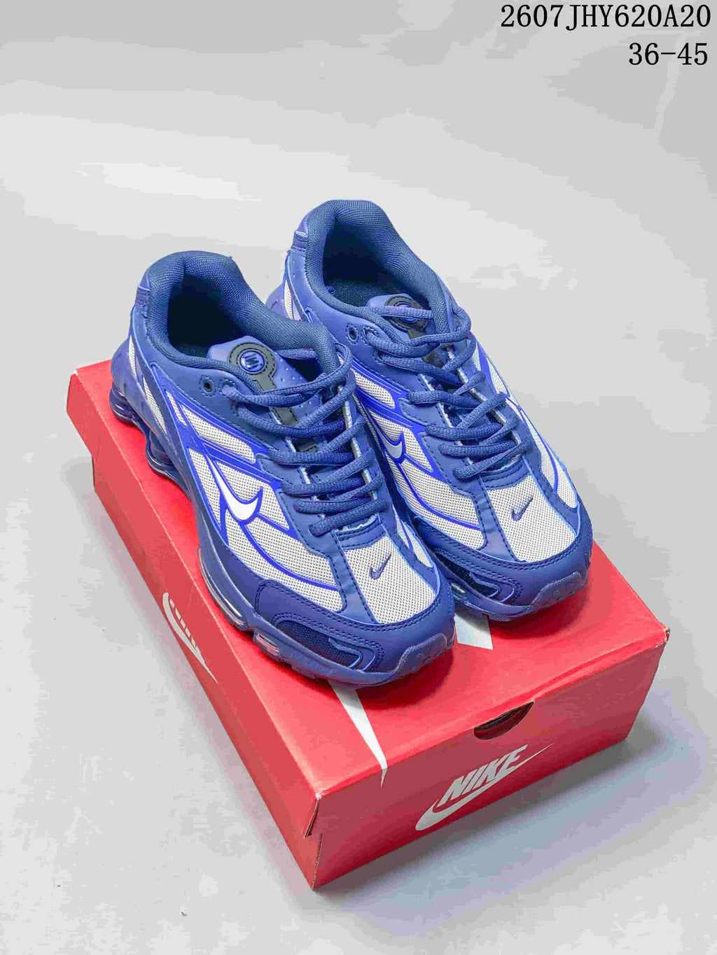 Blue and white Nike Shox Ride 2 sneakers displayed on a red shoebox; overlay text shows 2607JHY620A20 and sizes 36-45.
