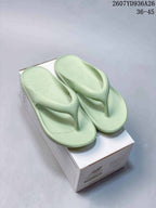 Pair of pale green New Balance thong sandals displayed on a branded shoe box; overlay text shows style code 2607YD936A26 and size range 36–45.