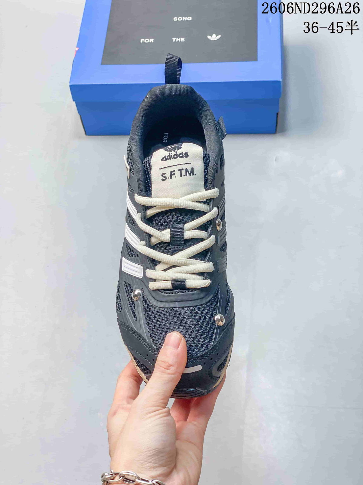 Top view showing the cream laces, dark textured upper, tongue label, and layered toe design.