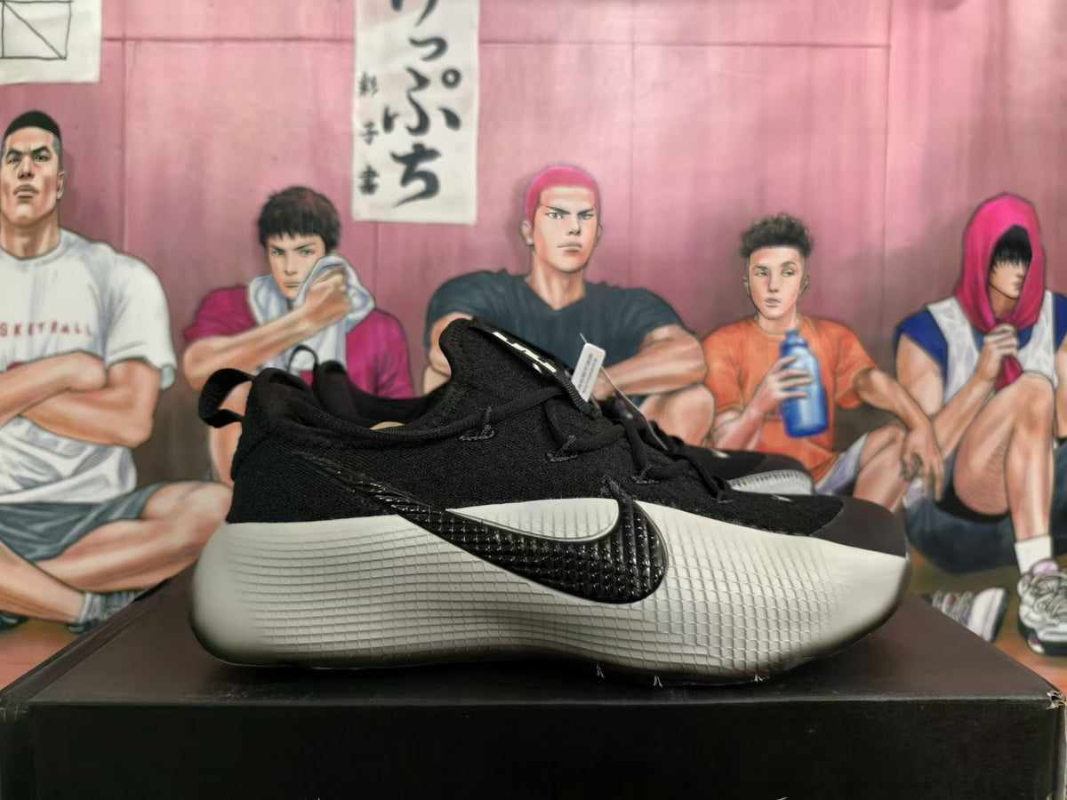 Side view showing a black Nike swoosh and textured silver-gray sole.