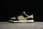 Full side profile showing the low-top silhouette and beige, black, and muted yellow color blocking.