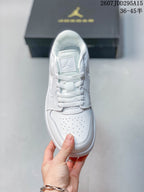 Top view of the white sneaker showing flat laces, tongue branding and perforations across the toe box.